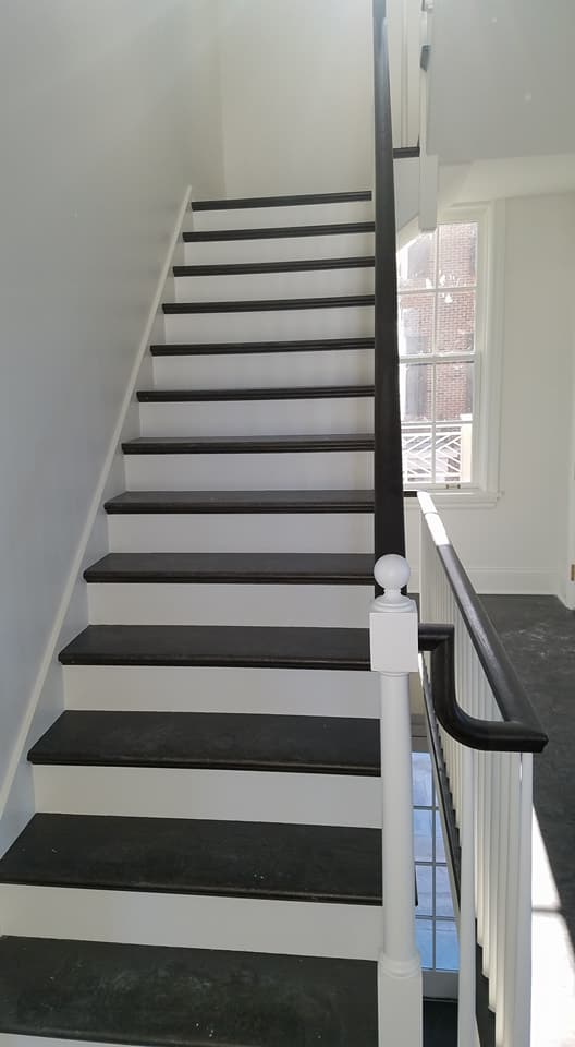 image shows wooden stairs after painting work